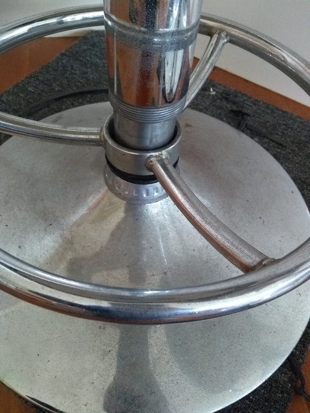Dusty chrome bar stool base before cleaning